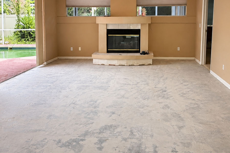 Clean concrete subfloor after professional floor removal using dust-control equipment