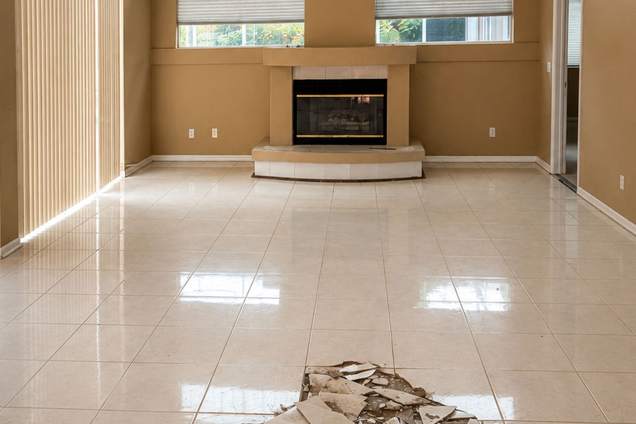 Old ceramic tile floor in residential living room before professional floor removal